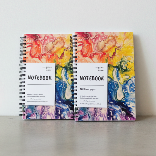 Two notebooks with colorful abstract designs on a white background