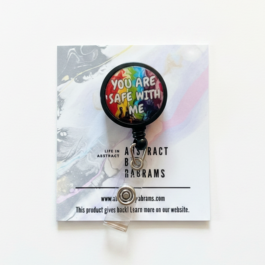 Retractable badge holder with rainbow design on a white card