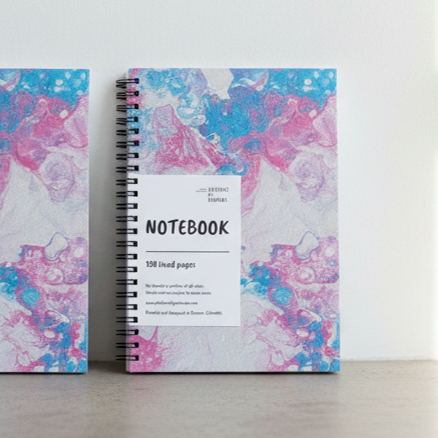 A notebook with a colorful cover design on a plain background