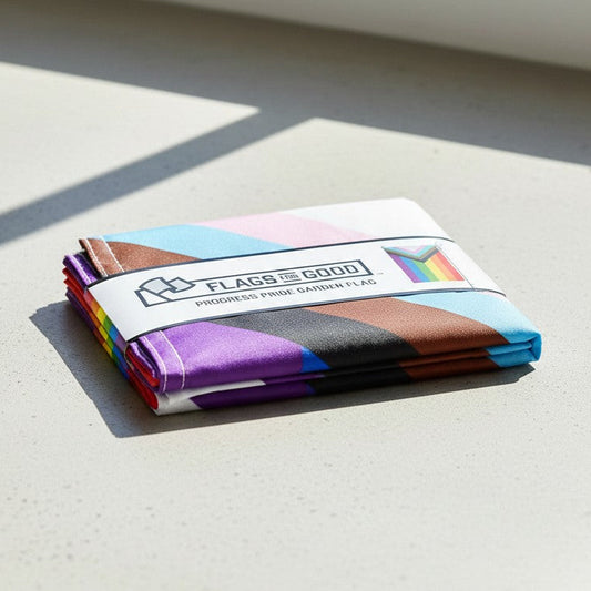 Folded colorful garden flag with a brand label on a light surface