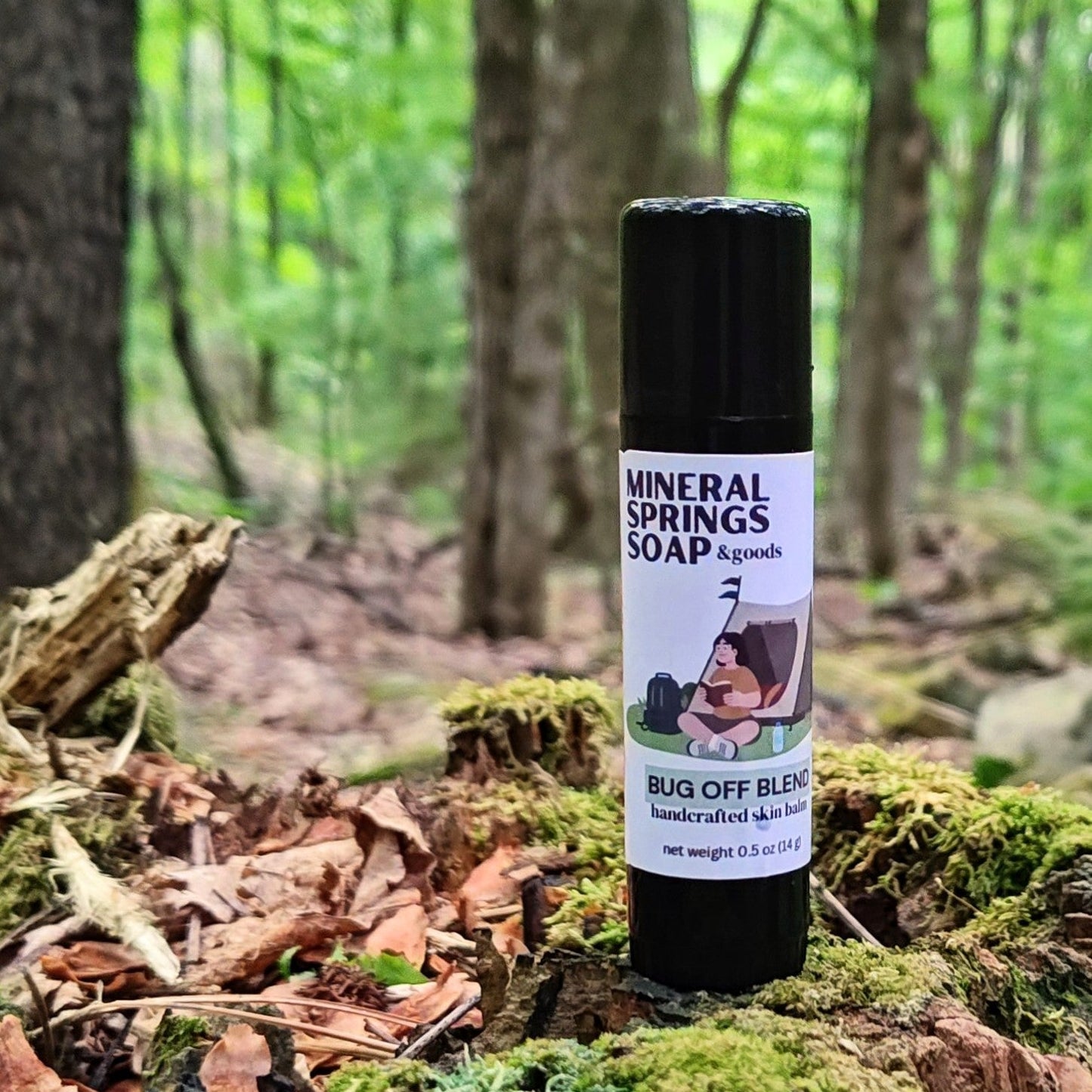 Mineral Springs Soap Bug Off Blend Skin balm on a moss covered stump in the woods