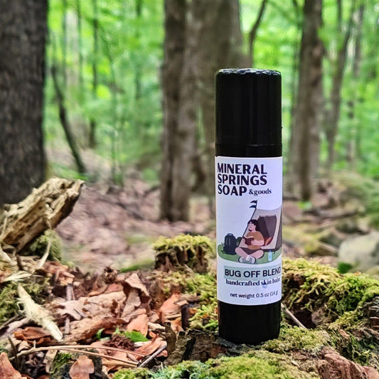 Mineral Springs Soap Bug Off Blend Skin balm on a moss covered stump in the woods
