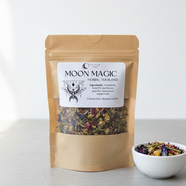 Moon Magic herbal tea blend package with a small bowl of tea leaves on a light background